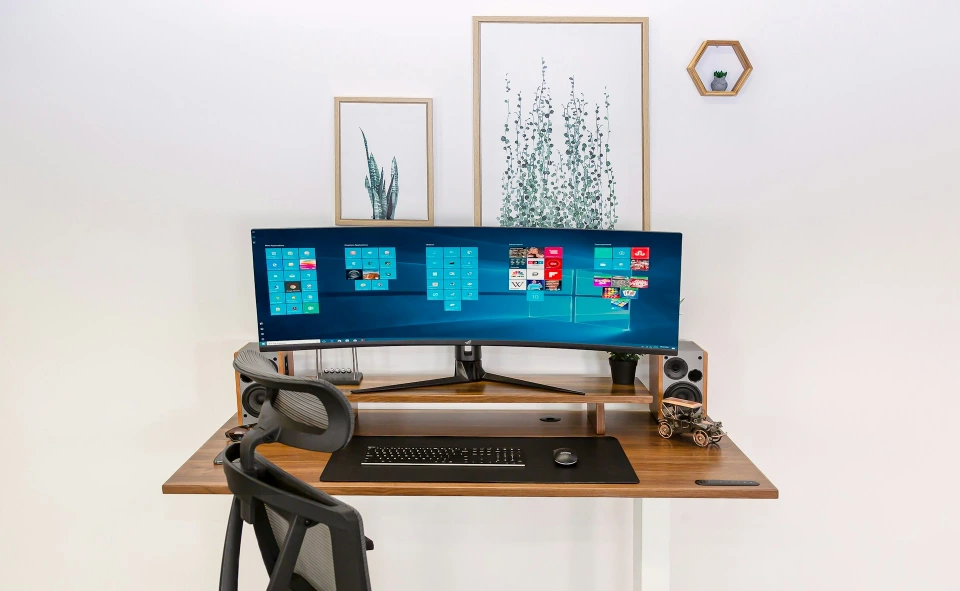 a computer monitor sitting on top of a wooden desk
